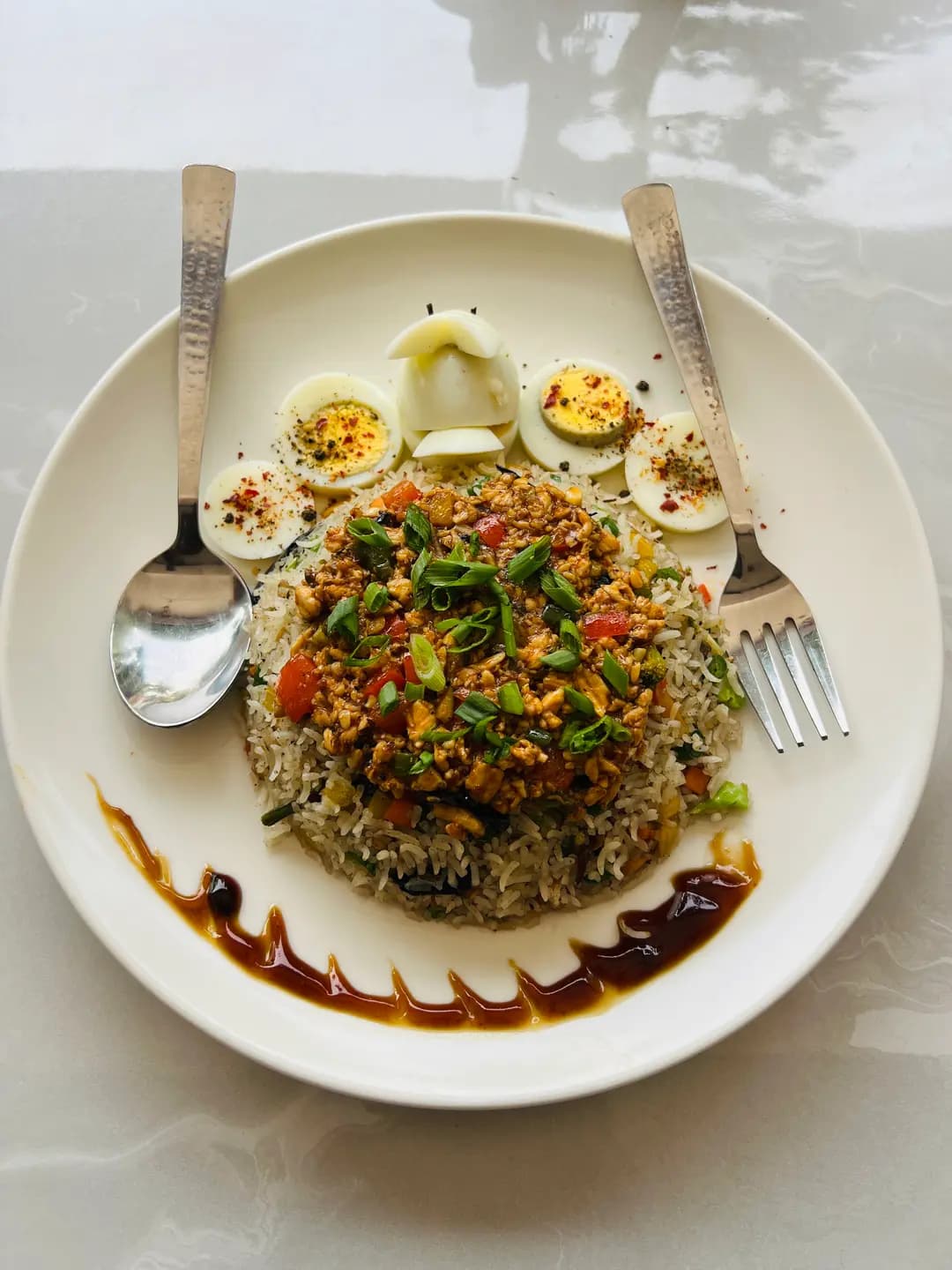 Chef plating Malabar prawn roast during service.